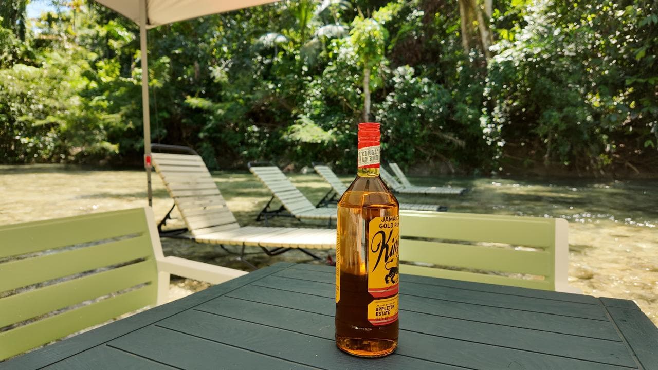 Guest relaxing in the river with a glass of wine